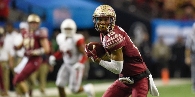 A middle schooler is seen joined by a Florida State football player