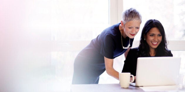 Mature business woman mentoring a younger woman.