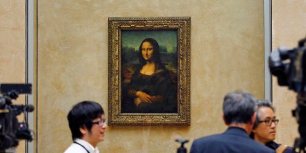 Members of the media are gathered next to Mona Lisa, during an event to unveil the new lighting of Leonardo da Vinci's painting Mona Lisa, also known as La Joconde, at the Louvre museum in Paris, Tuesday June 4, 2013. Mona Lisa is now illuminated by LED lighting. The lighting had to meet various technical specifications, but also meet the more subjective and aesthetic requirements of the museum Director and Franceâs Historical Monuments Committee.(AP Photo/Remy de la Mauviniere)