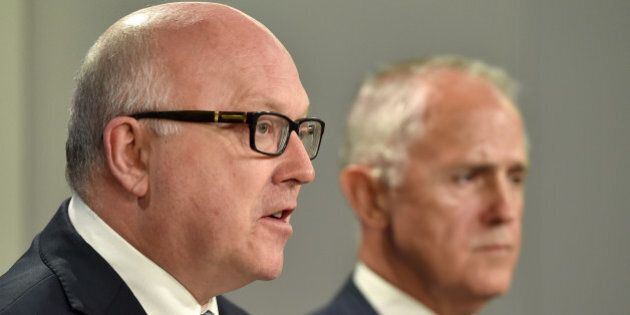 Australia's Attorney General George Brandis (L) speaks at a press conference Australia's Prime Minister Malcolm Turnbull looks on in Sydney on December 30, 2015. An Australian inquiry into trade union corruption reported 'widespread' and 'deep-seated' misconduct, with Turnbull urging reform and the establishment of an independent regulator. AFP PHOTO / Saeed KHAN / AFP / SAEED KHAN (Photo credit should read SAEED KHAN/AFP/Getty Images)