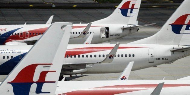 To go with AFP story 'MALAYSIA-CHINA-AUSTRALIA-AVIATION-ACCIDENT-LAW' FOCUS by Dan MartinA Malaysia Airlines flight attendant (top) prepares the aircraft prior to departure at Kuala Lumpur International Airport in Sepang on February 25, 2016. Malaysia Airlines flight MH370 next-of-kin have begun filing a slew of lawsuits over the plane's disappearance as a two-year deadline approaches on March 8, with some hopeful that court scrutiny will help reveal answers about what befell the ill-fated plane. AFP PHOTO / MANAN VATSYAYANA / AFP / MANAN VATSYAYANA (Photo credit should read MANAN VATSYAYANA/AFP/Getty Images)