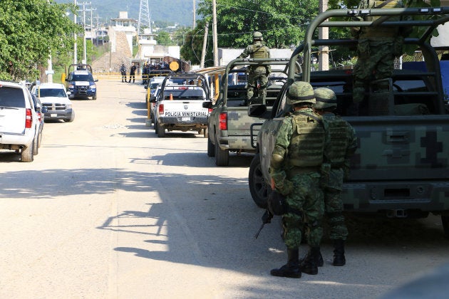 Soldiers and federal police officers set up a security cordon around the prison in the wake of the deadly fighting.