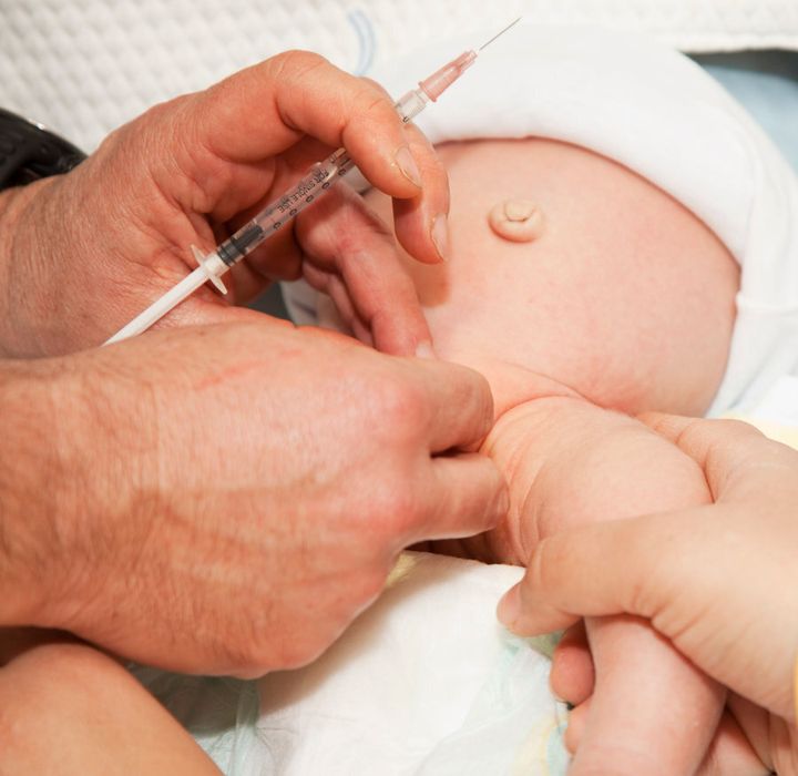 A baby boy in hospital being circumcised.