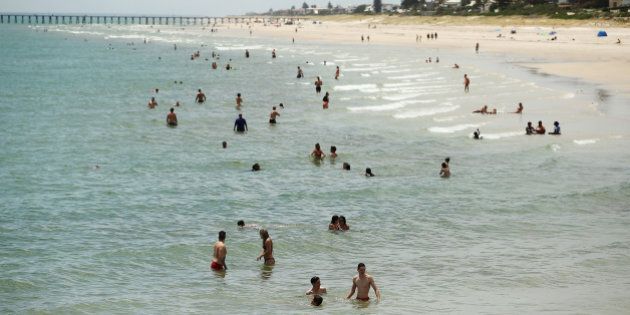ADELAIDE, AUSTRALIA - DECEMBER 19: Adelaide residents escape the heat at Henley beach on December 19, 2015 in Adelaide, Australia. Adelaide is experiencing an extreme heatwave, with temperatures reaching over 40 degrees for five consecutive days. (Photo by Morne de Klerk/Getty Images)