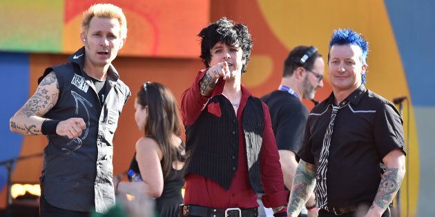Green Day's Billie Joe Armstrong (centre) has defended the band after they were criticised for performing a festival set after an accident resulted in the death of a performer.