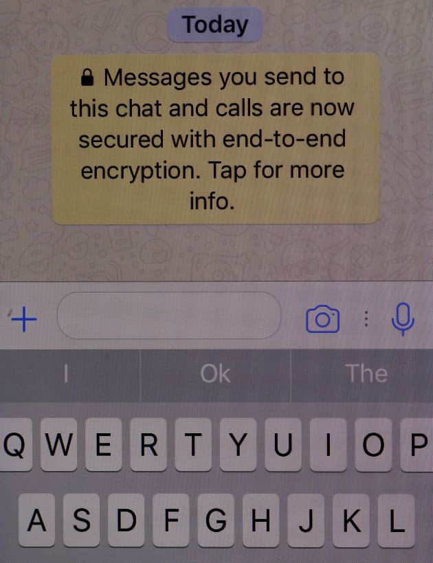 An encryption message is seen on the WhatsApp application on an iPhone