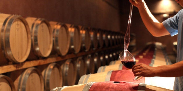 FLORENCE, ITALY - SEPTEMBER 23: An employee checks the Chianti Rufina Riserva wine at The Marchesi de Frescobaldi Nipozzano wine cellar on September 23, 2011 in Nipozzano Florence, Italy. The Castello di Nipozzano, built in year 1000 as a defensive fortress today houses the wine cellar, where the estate red wines are produced. The estate lies in the heart of the Chianti Rufina area, covering 626 hectares at elevations between 250 and 400 metres. (Photo by Franco Origlia/Getty Images)