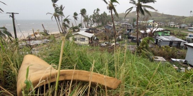 People inspect the damage at Namuimada village settlement on February 26, 2016, caused by Cyclone Winston which devastated Fiji. Humanitarian aid was finally reaching isolated communities in Fiji devastated by super-cyclone Winston, with the government estimating the damage bill will top hundreds of millions of dollars. At least 44 people died when the most powerful storm in Fiji's history hit on February 20 and the UN says about 50,000 -- more than five percent of the entire population -- have been left homeless. AFP PHOTO / STEVEN SAPHORE / AFP / STEVEN SAPHORE (Photo credit should read STEVEN SAPHORE/AFP/Getty Images)