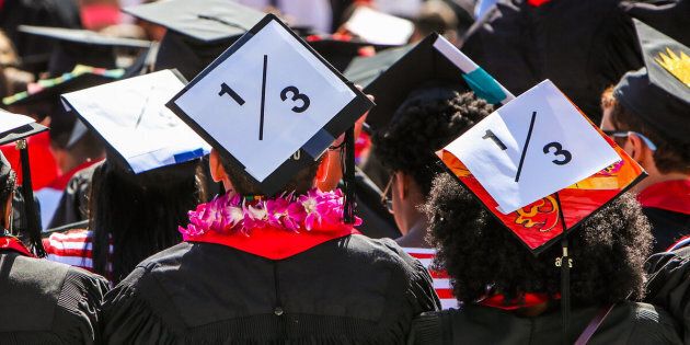 Stanford students wear a 1/3 sign on their caps to show solidarity for a Stanford rape victim during graduation ceremonies at Stanford University on June 12, 2016. The 1/3 stands for the statistic that 1 in three students will experience sexual assault by the time they graduate. 