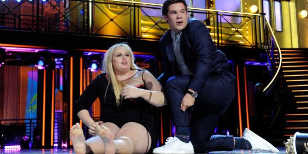 BURBANK, CALIFORNIA - APRIL 09: Actress Rebel Wilson (L) and actor Adam DeVine kiss while accepting the Best Kiss award for 'Pitch Perfect 2' onstage during the 2016 MTV Movie Awards at Warner Bros. Studios on April 9, 2016 in Burbank, California. MTV Movie Awards airs April 10, 2016 at 8pm ET/PT. (Photo by Emma McIntyre/Getty Images for MTV)