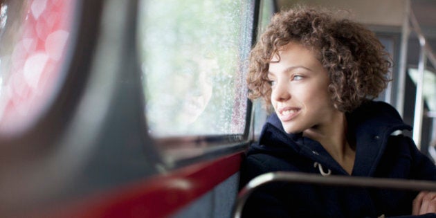 Smiling woman riding bus