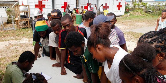 People sign up for assistance at a Red Cross aid centre, days after Cyclone Pam in Port Vila, capital city of the Pacific island nation of Vanuatu March 19, 2015. REUTERS/Edgar Su