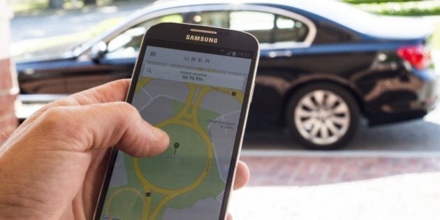 CANBERRA, AUSTRALIA - OCTOBER 30: A person uses the UberX app on October 30, 2015 in Canberra, Australia. The Australian Capital Territory is the first jurisdiction in the world to legalise UberX, allowing people to access and offer ridesharing services without fear of fines or license suspensions. (Photo by Martin Ollman/Getty Images)