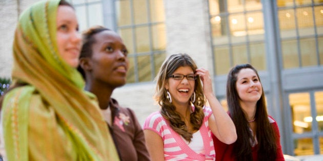 Low-angle view of women sitting together outside a building