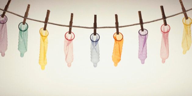 Condoms hanging on pegs from line