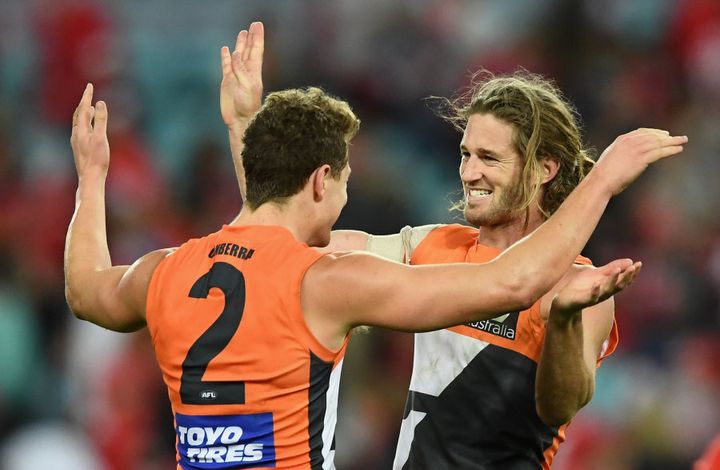 Giants co-captain Callan Ward (right) had plenty to smile about in his 150th game.