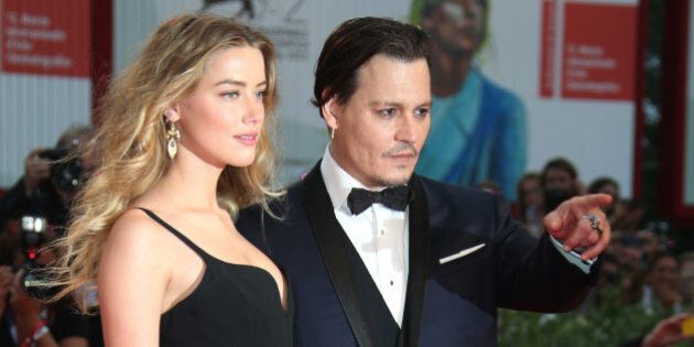 Amber Heard and Johnny Depp pose for photographers upon arrival at the premiere of the film Black Mass during the 72nd edition of the Venice Film Festival in Venice, Italy, Friday, Sept. 4, 2015. The 72nd edition of the festival runs until Sept. 12. (Photo by Joel Ryan/Invision/AP)