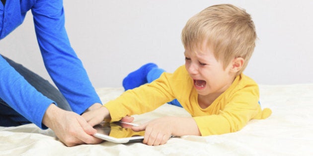 computer addiction, parent taking out touch pad from child