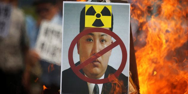 A cut-out of North Korean leader Kim Jong Un is set on fire during an anti-North Korea rally in central Seoul, South Korea, one day after the isolated nation conducted its fifth nuclear test.