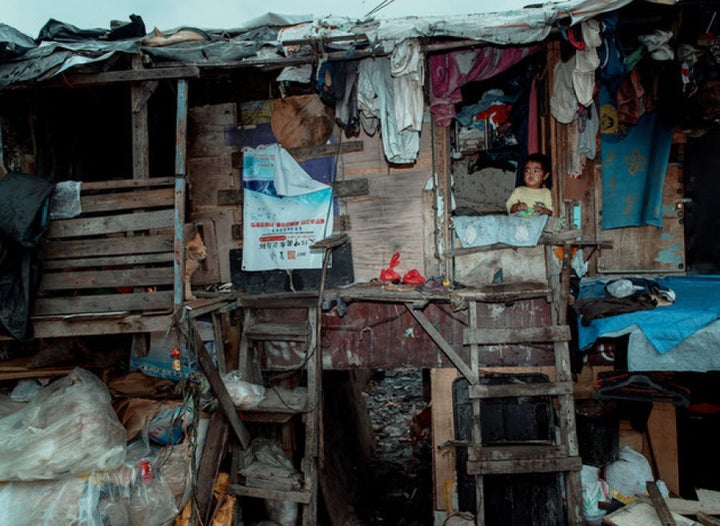 A small boy stares from his shack in Happyland.