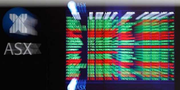 Stock information is displayed on an electronic board inside the Australian Securities Exchange, operated by ASX Ltd., in Sydney, Australia, on Friday, July 24, 2015. The Australian dollar slumped last week as a gauge of Chinese manufacturing unexpectedly contracted, aggravating the impact of declines in copper and iron ore prices. Photographer: Brendon Thorne/Bloomberg via Getty Images