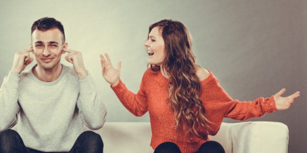 couple having argument - conflict, bad relationships. Angry fury woman screaming man closing his ears.