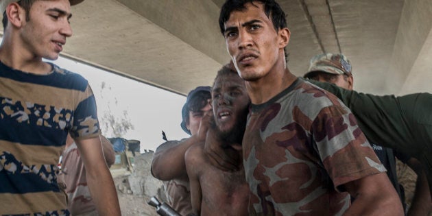 MOSUL, IRAQ - JULY 10: A man suspected of being an Islamic State militant is detained by the Iraqi Army in the Old City district on July 10, 2017 in Mosul, Iraq. The Iraqi government and armed forces have declared victory but fighting continues. (Photo by Martyn Aim/Corbis via Getty Images)