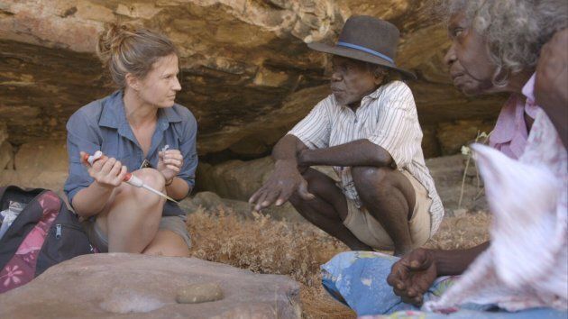 Elspeth Hayes examining some of the finds with Mark Djandjomerr and traditional owner May Nango at a cave near Madjedbebe.