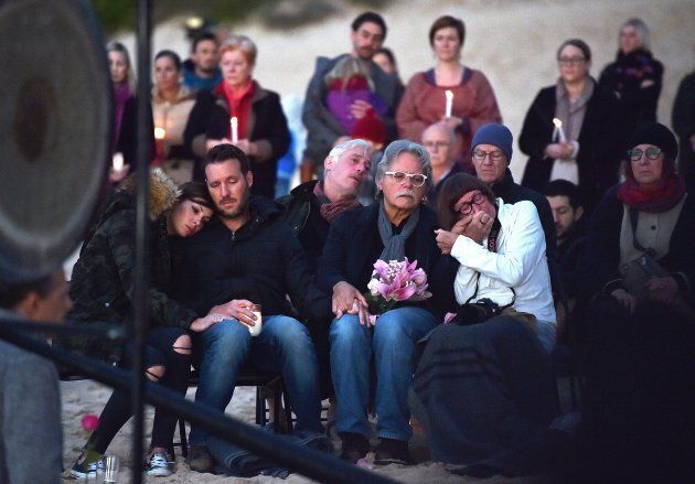Justine Damond's family at a vigil held on Freshwater beach on Wednesday morning. Her brother Jason Ruszczyk (second from left) with wife Katarina sit next to Justine's father John Ruszczyk and his wife Maryan Heffernan.