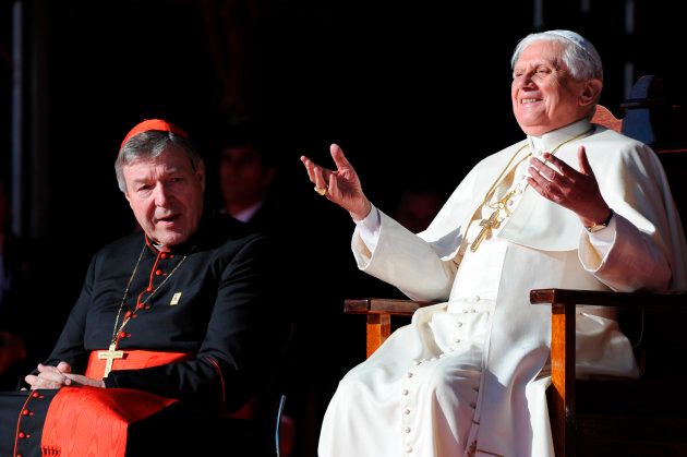 Pope Benedict XVI gestures as he sits next to Australia's senior Catholic cleric Cardinal George Pell (L) at a ceremony to thank World Youth Day volunteers at The Domain in Sydney July 21, 2008.