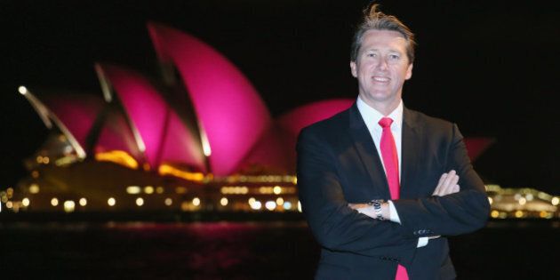 SYDNEY, AUSTRALIA - SEPTEMBER 16: Glen McGrath stands in front of the Sydney Opera House, with its sails turned pink to commemorate ten years of placing McGrath Breast Care Nurses in communities across Australia, on September 16, 2015 in Sydney, Australia. (Photo by Don Arnold/WireImage)