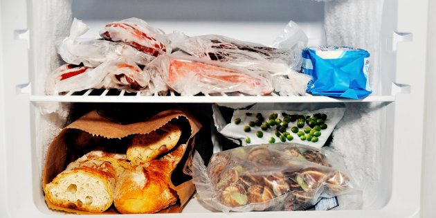 Freezer compartment of a refrigerator containing meat and frozen vegetables as well as bread