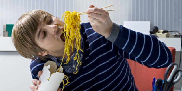 young office worker eating asian food