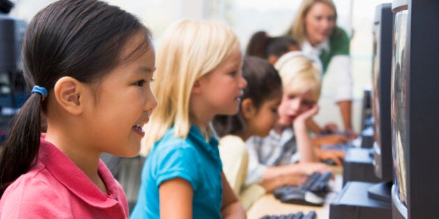 Kindergarten children learning how to use computer