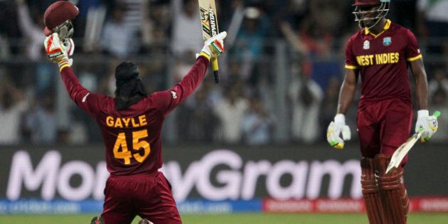 West Indiesâ Chris Gayle raises his bat after scoring hundred runs against England during their ICC World Twenty20 2016 cricket match at the Wankhede stadium in Mumbai, India, Wednesday, March 16, 2016. (AP Photo/Rafiq Maqbool)