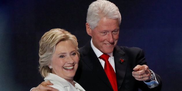 U.S. Democratic presidential nominee Hillary Clinton stands with her husband, former President Bill Clinton.