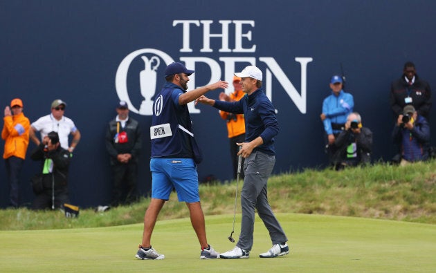 All good, bro. Player and caddie celebrate victory on the 18th with no offence taken.