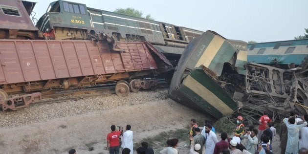 MULTAN, PAKISTAN - SEPTEMBER 15: Pakistani people and rescue team members inspect the site of the train accident in Multan, Pakistan on September 15, 2016. According to the reports at least 6 people killed and more than 100 injured after the crash. (Photo by Shakeel Khan/Anadolu Agency/Getty Images)