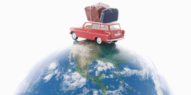 Toy car with luggages on the globe.