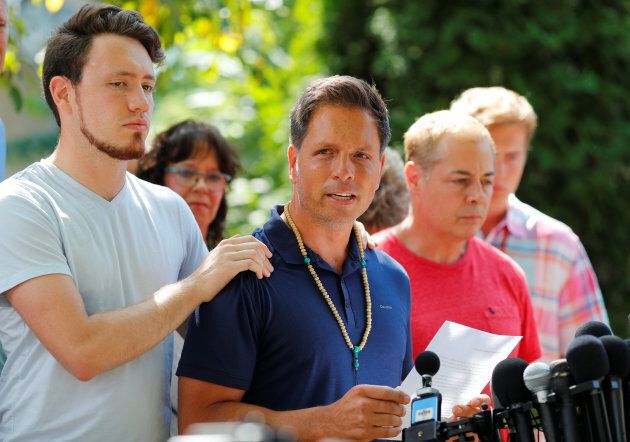 Don Damond is comforted by his son Zach Damond as he speaks to the media about his fiance, Justine Damond was fatally shot by Minneapolis police on July 17.