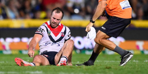 TOWNSVILLE, AUSTRALIA - MARCH 17: Ian Henderson of the Roosters points to his lower leg after being injured during the round three NRL match between the North Queensland Cowboys and the Sydney Roosters at 1300SMILES Stadium on March 17, 2016 in Townsville, Australia. (Photo by Ian Hitchcock/Getty Images)