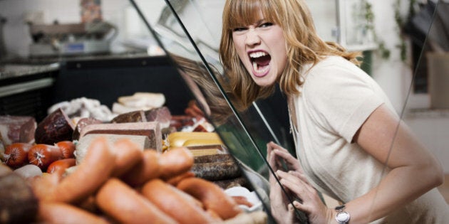 Woman in front of window display.