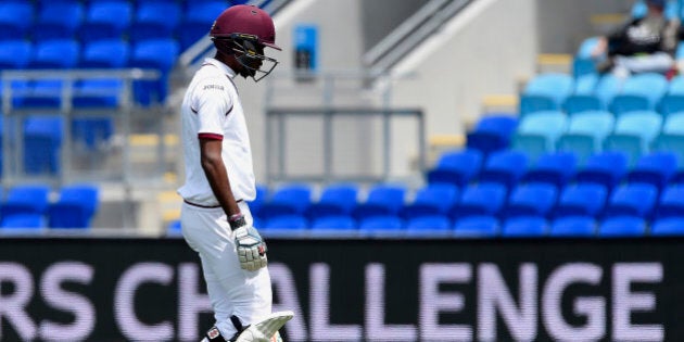 West Indies' Kraigg Brathwaite walks off the field being dismissed by Australia's Josh Hazlewood during their cricket test match in Hobart, Australia, Friday Dec. 11, 2015. (AP Photo/Andy Brownbill)