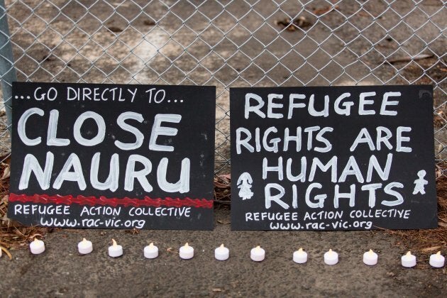 Banners and candles at the gates of a refugee detention centre during a candlelight vigil as protestors stand in solidarity with refugees in detention in Melbourne, February 2016