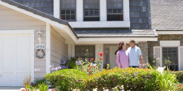 Couple Standing Outside Their House