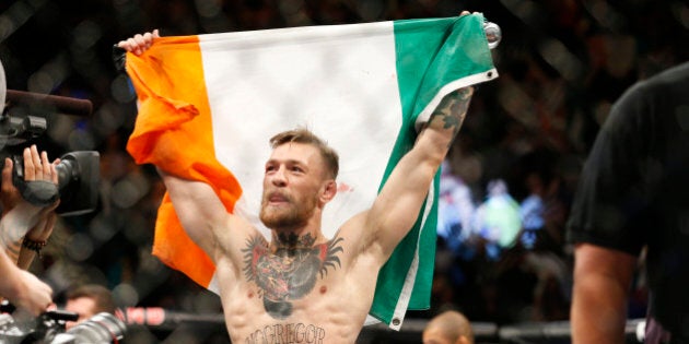 Conor McGregor reacts after defeating Jose Aldo during a featherweight championship mixed martial arts bout at UFC 194, Saturday, Dec. 12, 2015, in Las Vegas. (AP Photo/John Locher)