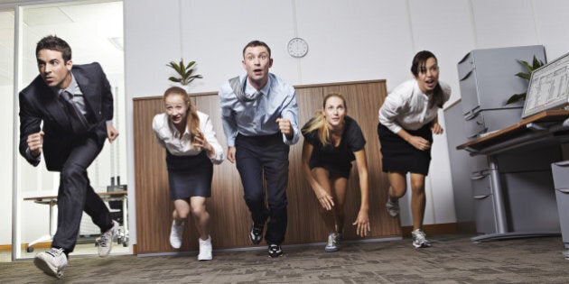 Businessmen and businesswomen racing in office