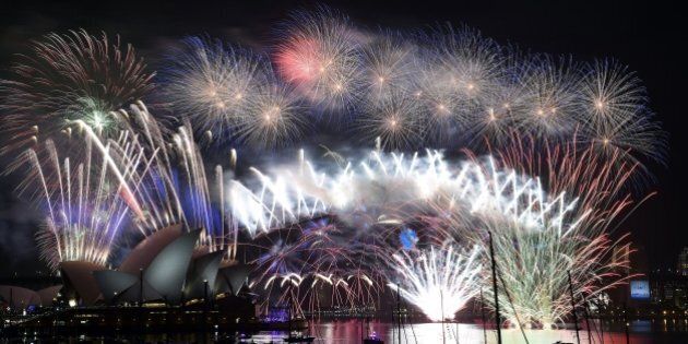 New Year's fireworks erupt over Sydney's iconic Harbour Bridge and Opera House during the traditional fireworks at midnight on January 1, 2015. AFP PHOTO / Saeed KHAN (Photo credit should read SAEED KHAN/AFP/Getty Images)