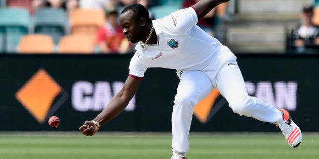 West Indies' bowler Kemar Roach fields off his own bowling against Australia during their cricket test match in Hobart, Australia, Thursday, Dec. 10, 2015. (AP Photo/Andy Brownbill).