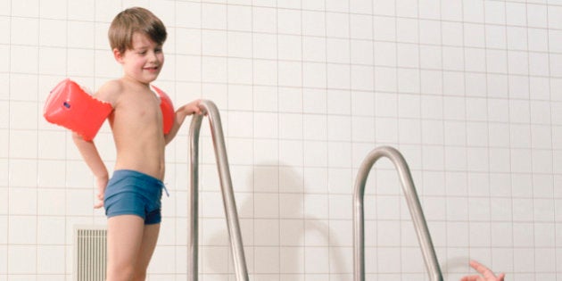 Mother encouraging Son in Swim-wings